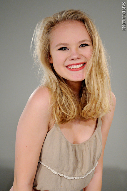 headshot of pretty teen female blonde, blue-eyes and a big smile