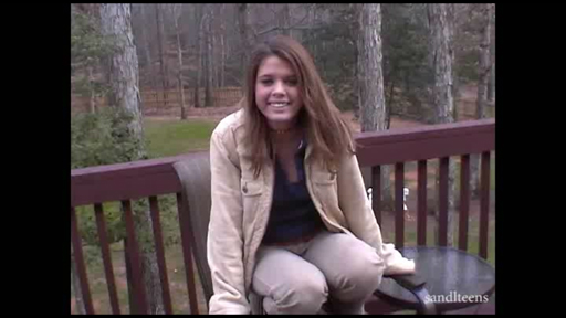 female teen wearing a heavy coat sitting on the deck