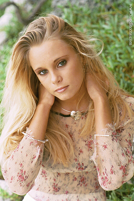 beautiful blonde teen female model wearing a thin, lace top